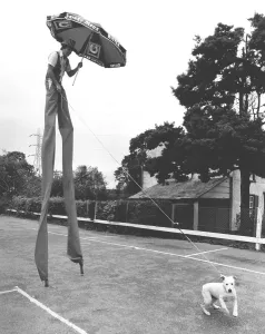 Man on stilts with dog, England, Great Britain