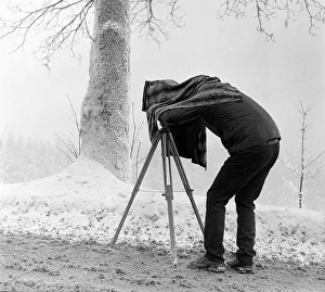 Man taking pictures with a plate camera