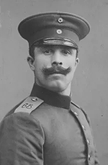 Man in uniform and cap, moustache