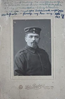 Man in uniform jacket and with cap
