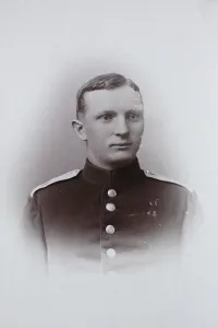 Man, in uniform jacket, visiting format