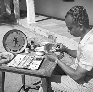 Man using portable rotating lathe applying lacquer wringtinforia wood, painting lacquer toys, Channapatna, Karnataka