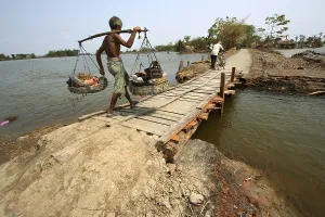 Category Historic EN Prints: Man walking with kavad on footbridge