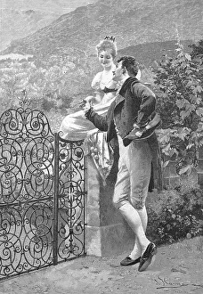 Man and woman flirting at a garden gate in summer