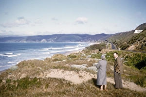 Man and woman standing in the sand dunes on a sandy beach near Anglesea, Victoria, Australia, 1956, Oceania