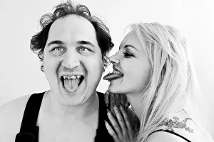 Man and woman sticking out their tongues