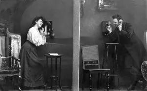 Man and woman telephoning, historical photo