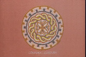 Mandala made of pearls in warm colors on a pink background with Cordoba lettering