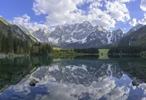 The Mangart mountain range reflected in Lake Fusine