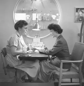 At the manicurist 1955. A manicurist is tending to her nails and applies nail polish of the desired color. October 1955