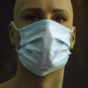 A mannequin displays a light blue surgical mask