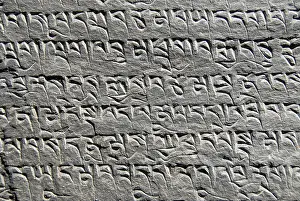 Mantra chisled in rock Kyi Chu valley Tibet China