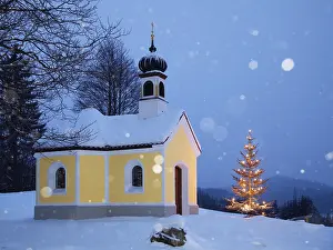 Maria Rast chapel with Christmas tree during snowfall