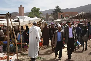 Framed Print : Market scene in Msemrir with people walking along the stalls