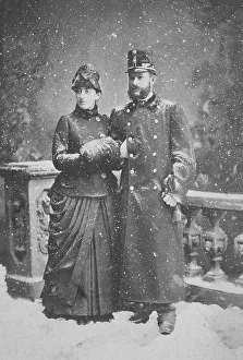 Married couple standing in the snowfall
