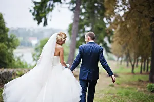 Married walking in the rain at park