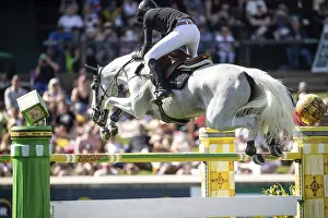 Martin Fuchs of Switzerland and riding Leone Jei compete in the first round of the 1