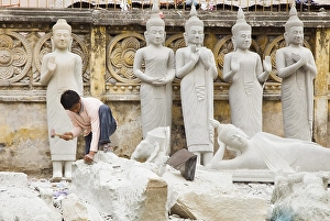Category Buddhism Prints: Mason making Buddha figures, Phnom Penh