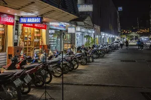 Massage parlor employees waiting for customers along a street in Chiang Rai