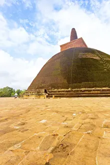 Massive Abhayagiri dagoba or stupa stands atop masonry base with intact spire in the ancient capitol of Anuradhapura