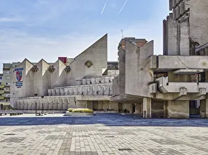 Massive brutalist concrete architecture in an urban environment with geometric shapes