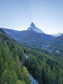 Matterhorn Mountain and Green Larches in Autumn in Evening