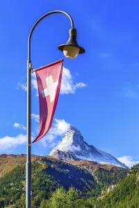 Matterhorn snow mount, Swiss flag and street light close-up