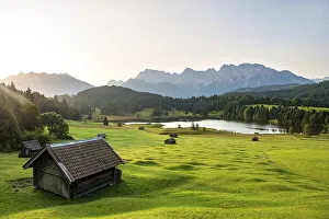 Meadow with small huts, hay barns