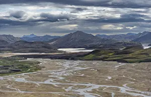 Meandering river in volcanic landscape with mountains