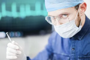 Medical professional focused on procedure details