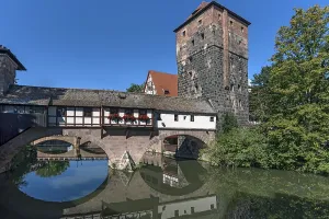 Medieval hangmans bridge and former water tower with reflection in the Pegnitz