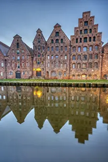 The medieval salt warehouse with the river Trave at dawn