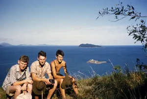 Melbourne Grammar School expedition to Queensland, Australia, 1956 three boys sit on the shore thought to be the Whitsunday Islands, Oceania