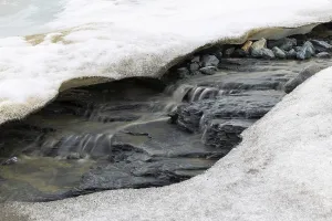 Melting glacier, stones, water