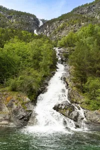 Melting snow waterfall flowing into Naeroyfjord