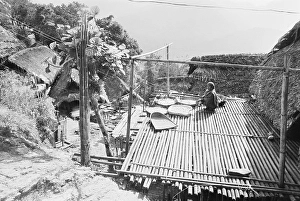 Member of Nocte tribe in Tirap dis trict drying vegetables on bamboo platform, Arunachal Prades h, India 1982