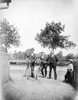Men with bicycles, cyclists, hat