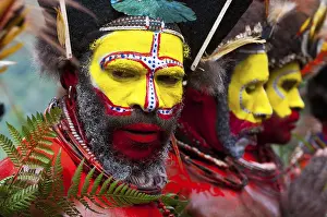 Men in colourfully decorated costumes with face