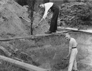 Two men digging a hole, 1940s, exact place unknown