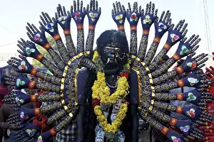 Men dress as Hindu Goddess Kali near Mutharamman temple