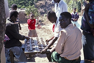 Men playing Bao, a traditional Mancala board game, Malawi, southern Africa, 1995, Africa