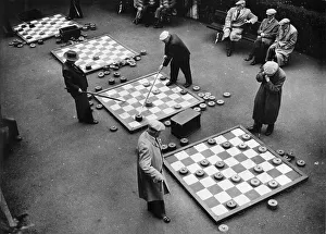 Men playing drafts, historical photo, circa 1920
