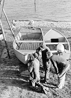 Three men repairing a boat, 1960s