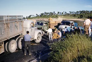 Men and trucks gather at site of road traffic accident, unspecified location, Spain, Europe