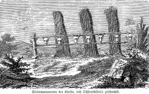 Menhirs of the Khasi decorated with skulls of oxen for festivities, indigenous people, today in the state of Meghalaya, megalithic memorial stones, India, vertical stones, open natural landscape, history of mankind, historical illustration 1880