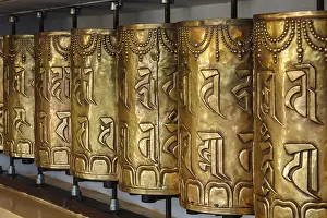 Category Buddhism Prints: Metal buddhist prayer wheels in Tsuglagkhang complex in Dalai Lama residence
