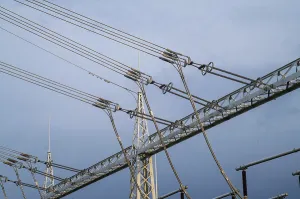 Metal framework supporting high-voltage power lines at an electrical substation