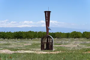 A meteorological device with a wide view of fields and mountains