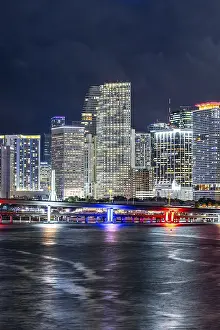 Miami skyline with high-rise real estate in downtown by the ocean at night in Miami
