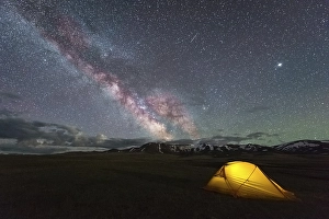 Category Mountain Landscapes Prints: Milky Way on Starry Night Sky with Airglow and Yellow Glowing Tent